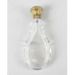 A 19th century yellow metal-topped glass scent bottle. The body of facetted teardrop form, the