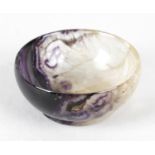 An unusual small Blue John bowl. Of hemispherical form, half with purple banding and small rings,