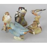 A group of Royal Worcester and other bird figurines. Comprising: thirteen Royal Worcester to include