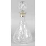 A cut glass decanter and stopper, of mallet shaped form with applied silver collar, the stopper of