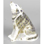 A Royal Crown Derby porcelain paperweight modelled as a wolf (signature edition), with red printed