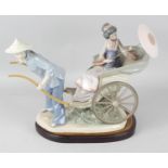 A large Lladro figure group, 'Ride in China', modelled as a male figure pulling a rickshaw