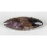 A Blue John brooch. Treak Cliff Blue vein, the slender navette cabochon to a metal backing with