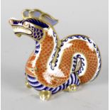 A Royal Crown Derby porcelain paperweight modelled as a dragon, with red printed marks and gold