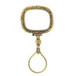 A mid Victorian gold magnifying glass. The cushion-shape lens, with floral and foliate engraved