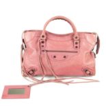 BALENCIAGA - a pink Classic City handbag. Crafted from distressed pink leather, featuring maker's