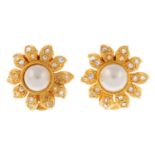 CHANEL - a pair of clip-on earrings. Each designed as a flower with clear pastes set along the