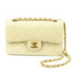 CHANEL - a small cream Classic Double Flap handbag. Designed with maker's cream diamond quilted