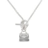 HERMÈS - a Kelly necklace. Designed as a small Kelly handbag charm to the thin belcher-link chain