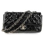 CHANEL - a patent leather Single Flap Icon handbag. Crafted with a black patent leather exterior