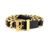 CHANEL - a belt. Designed as a chunky gold-tone chain with interwoven black leather to the matte