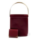 CARTIER - a Bordeaux Trinity handbag with coin purse. The handbag, designed with a burgundy