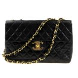 CHANEL - a vintage Maxi Classic Flap handbag. Crafted from diamond quilted, smooth black lambskin