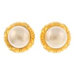 CHANEL - a pair of clip-on earrings. Designed with central imitation pearls and textured gold-tone