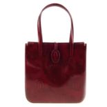 CARTIER - a Happy Birthday Bordeaux handbag. Designed with a structured square shape, burgundy