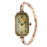 ROLEX - a lady's 1920s 9ct gold wrist watch. The rectangular-shape dial, with Arabic numerals and