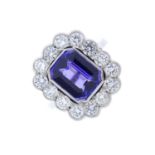 A tanzanite and diamond cluster ring. The rectangular-shape tanzanite, with brilliant-cut diamond