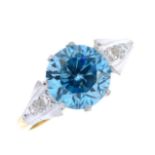 A zircon and diamond dress ring. The circular-shape blue zircon, with single-cut diamond tapered