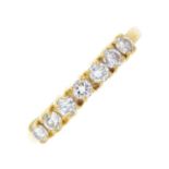 An 18ct gold diamond half eternity ring. Designed as a brilliant-cut diamond line, with plain