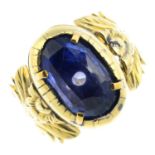 A late Georgian gold sapphire single-stone ring. The oval-shape sapphire, with embossed foliate