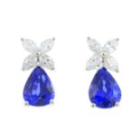 A pair of sapphire and diamond earrings. Each designed as a pear-shape sapphire, with marquise-shape