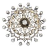 A late Victorian silver and gold diamond brooch. Of openwork design, the old-cut diamond flower,