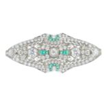 A diamond and emerald brooch. The slightly graduated old-cut diamond line, spaced to the calibre-cut