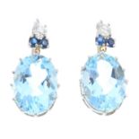 A pair of diamond, aquamarine and sapphire earrings. Each designed as an oval-shape aquamarine, with