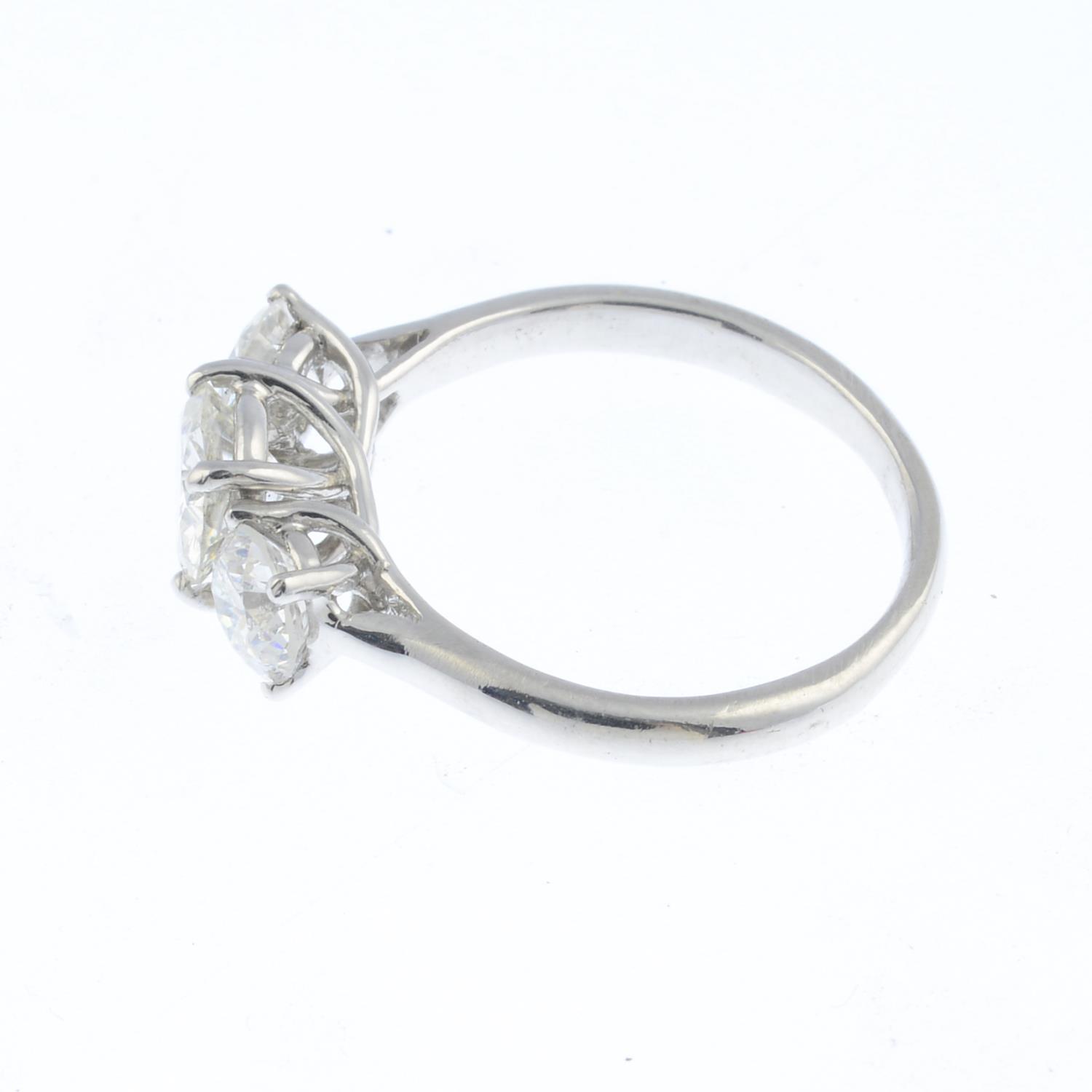 A diamond three-stone ring. Designed as a graduated brilliant-cut diamond line, with crossover - Image 3 of 3
