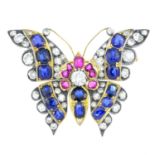 A diamond, sapphire and ruby brooch. Designed as a butterfly, the old-cut diamond, cushion-shape