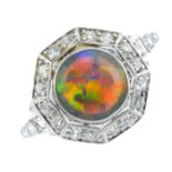 An Art Deco platinum opal and diamond cluster ring. The circular opal cabochon, with single-cut