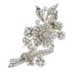 A late Victorian silver and gold diamond brooch. Designed as an old-cut diamond openwork floral