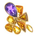 An amethyst and citrine dress ring. Designed as a pear-shape amethyst and vari-shape citrine