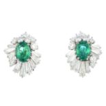 A pair of emerald and diamond cluster earrings. Each designed as an oval-shape emerald, with