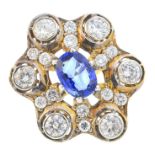 A sapphire and diamond cluster ring. Of openwork design, the oval-shape sapphire, with brilliant-cut