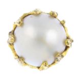A mid 20th century 14ct gold mabe pearl ring. The mabe pearl, with textured mount and band. Diameter