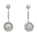 A pair of diamond earrings. Each designed as a rose-cut diamond openwork cluster, suspended from a