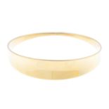 HANS HANSEN - a 14ct gold bangle. The concave panel, with tapered sides. Facsimile signature for
