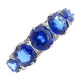 A late Victorian gold sapphire five-stone ring. The graduated circular-shape sapphire line, with