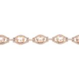 A morganite and diamond bracelet. Comprising a series of oval-shape morganite links, with