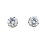 A pair of brilliant-cut diamond stud earrings. With two reports, dated 8th March 1981, from Yun Thye