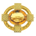 A late Victorian gold citrine and enamel brooch. The oval-shape citrine, with bead and white