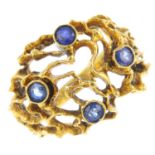 A 1960s 18ct gold sapphire dress ring. Of openwork design, the free form wirework, tapered bombe