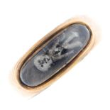 A late Georgian gold mourning ring. Comprising a white skeleton, on woven hair, beneath a domed oval