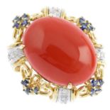 A coral, diamond and sapphire dress ring. Of openwork design, the oval coral cabochon, with