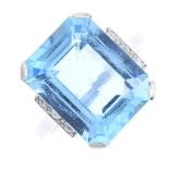 An aquamarine and diamond ring. The rectangular-shape aquamarine, with single-cut diamond line