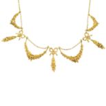 An early 20th century gold seed pearl necklace. Designed as a series of floral swags and ribbons,