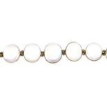 An early 20th century gold moonstone bracelet. Designed as a graduated oval moonstone cabochon line,