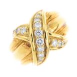 TIFFANY & CO. - a diamond 'Signature X Kiss' ring. Designed as a brilliant-cut diamond cross, atop a