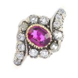 A late Victorian gold and silver ruby and diamond cluster ring. The oval-shape ruby, with old-cut